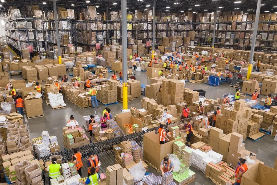 Busy fulfillment floor with workers packing boxes